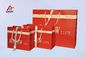 Red Art Paper Bags / Colored Paper Gift Bags Middle Hole Glued White Ribbon​ supplier